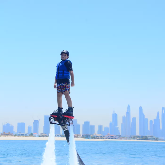 Kid flyboarding with Dubai skyline as background