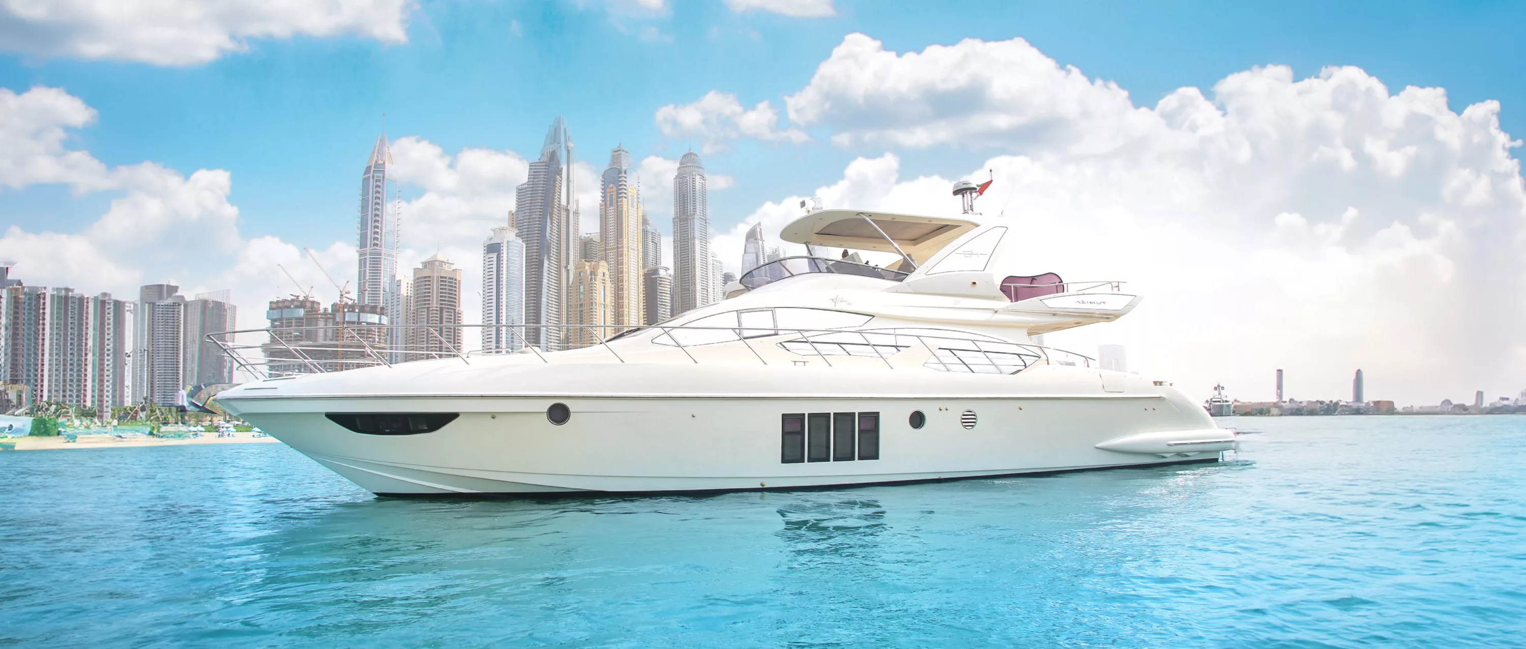 Hydro Water Sports 64ft yacht floating in the waters off Dubai, UAE, with sleek white design and a panoramic city skyline filled with modern high-rises behind it.