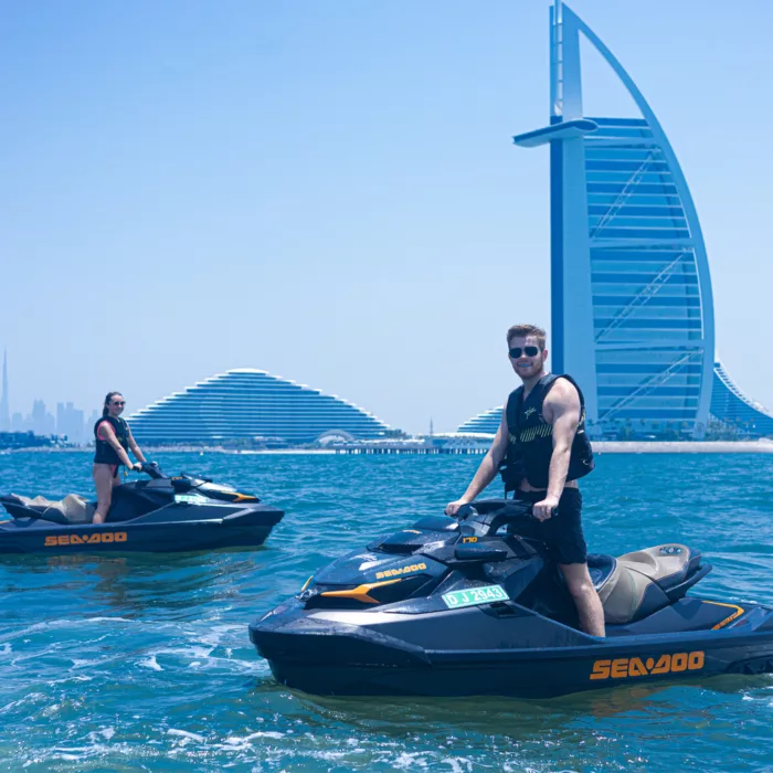 Two people on jet skis in front of Burj Al Arab