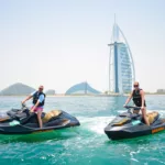 Two beginners jet skiing in Dubai in front of Burj Al Arab, Dubai, UAE