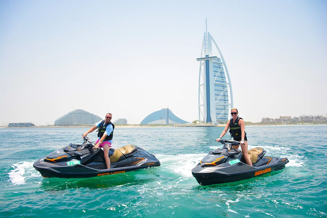 Two beginners jet skiing in Dubai in front of Burj Al Arab, Dubai, UAE