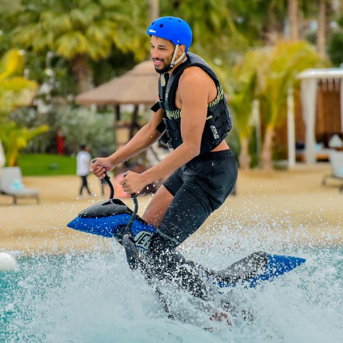 A man on a Jetovator in Dubai with water splashing