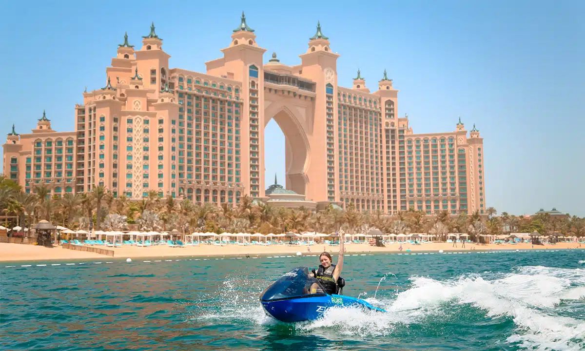 Guest riding the eWave electric water scooter in front of Atlantis, The Palm, offered by Hydro Water Sports